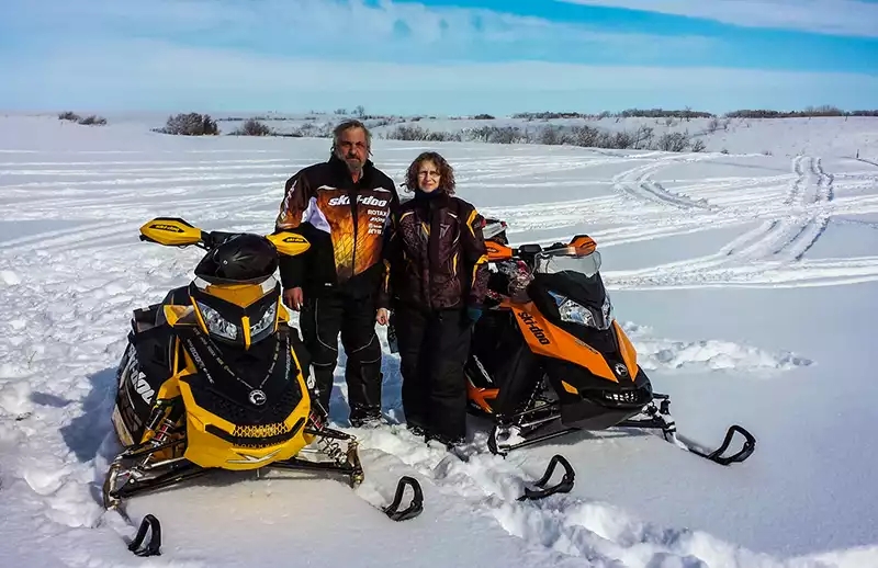 David Aksomitis and Linda Aksomitis on their snowmobiles near their home in Qu'Appelle, Saskatchewan.