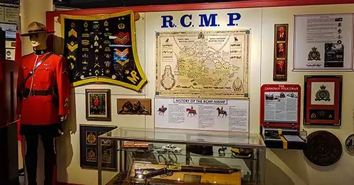 Mannequin displaying an RCMP uniform, along with various memorabilia and a short history in print materials. 