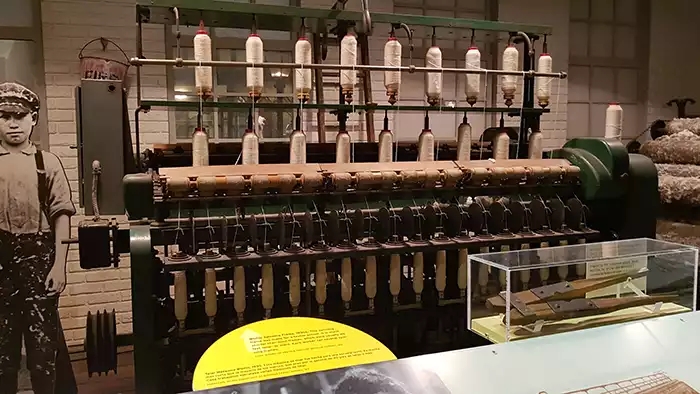 Whitin spinning frame with 18 spools of cotton thread. 