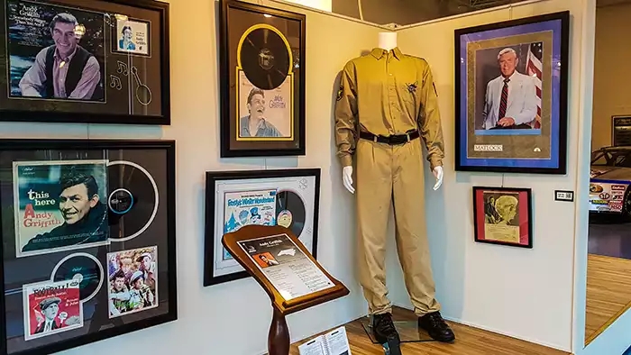 Photos of Andy Griffith, along with his sheriff's uniform and badge, and his album covers.  