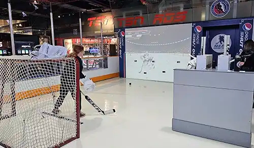 Visitor to the Hockey Hall of Fame Museum playing the interactive game defending the net. 