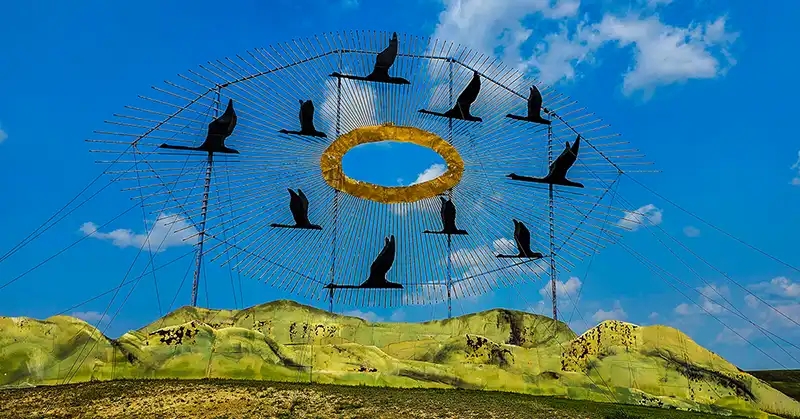 Metal sculpture of flying geese. 