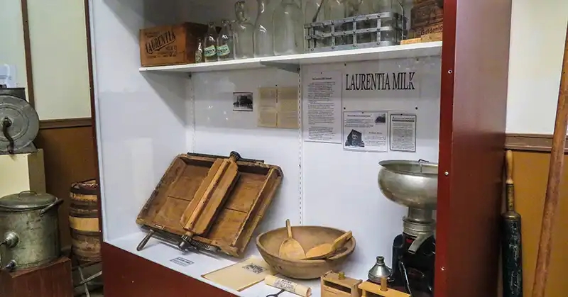 Various milk production related artifacts including a milk separator and Laurentia milk bottles and crates. 